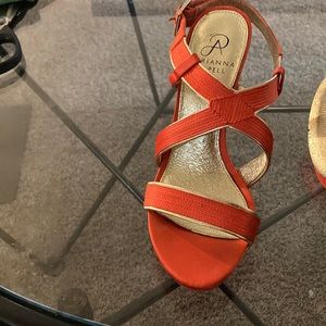 Adrianna Papel high heeled orange strapped sandal with gold leather trim.